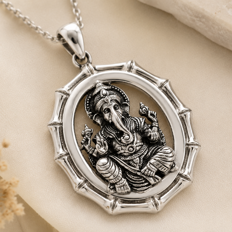 Silver pendant with an engraved figure on a beige background