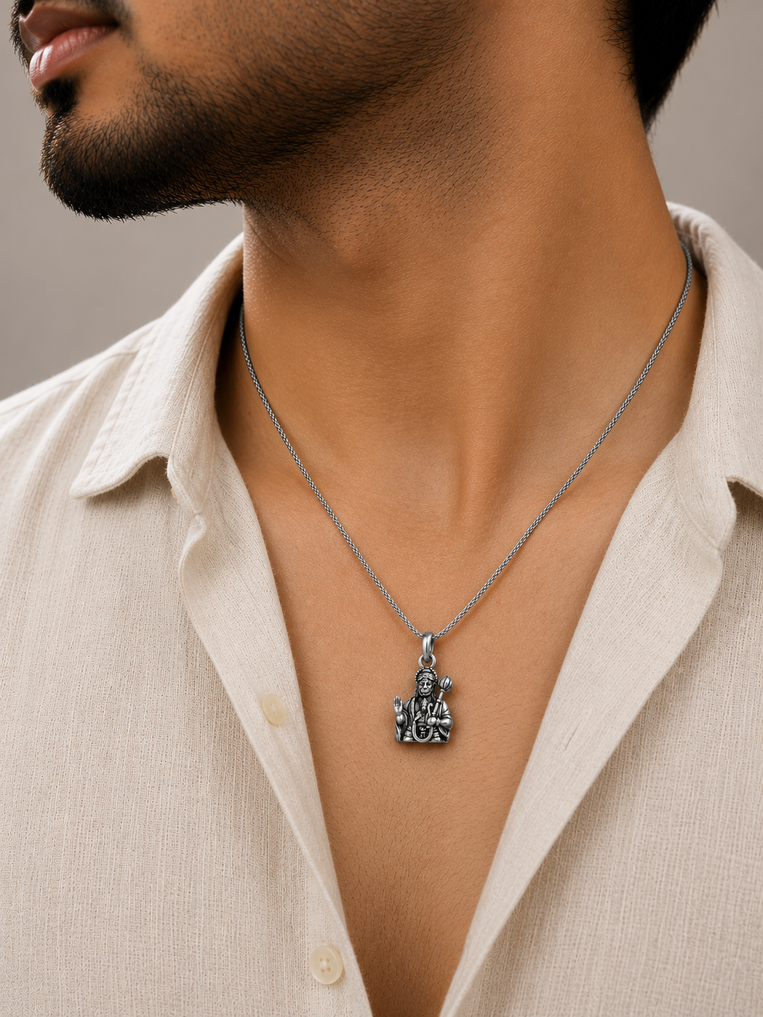 Spiritual silver Hanuman pendant styled with traditional attire