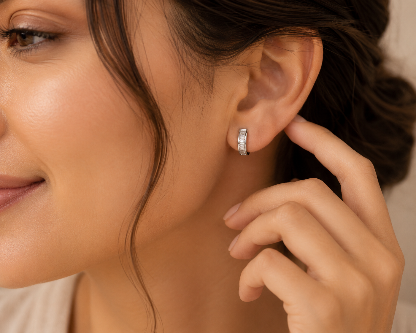 Close-up of slim hoop earrings showcasing brilliant CZ stone detailing