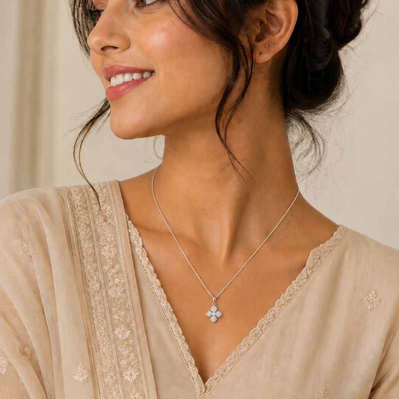 Woman wearing a delicate necklace with a subtle pendant against a neutral background