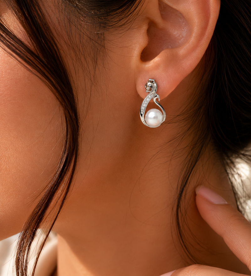 Elegant pearl and CZ swirl stud earrings close up