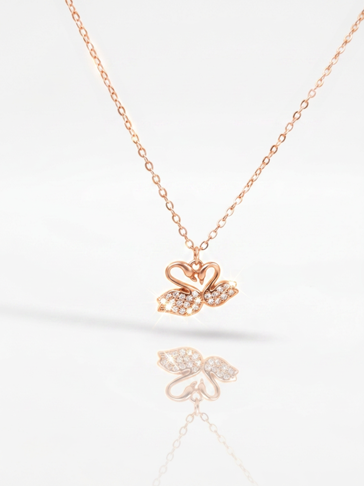 Delicate silver chain featuring elegant twin swan pendant centerpiece