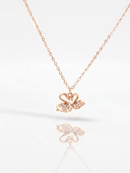 Delicate silver chain featuring elegant twin swan pendant centerpiece