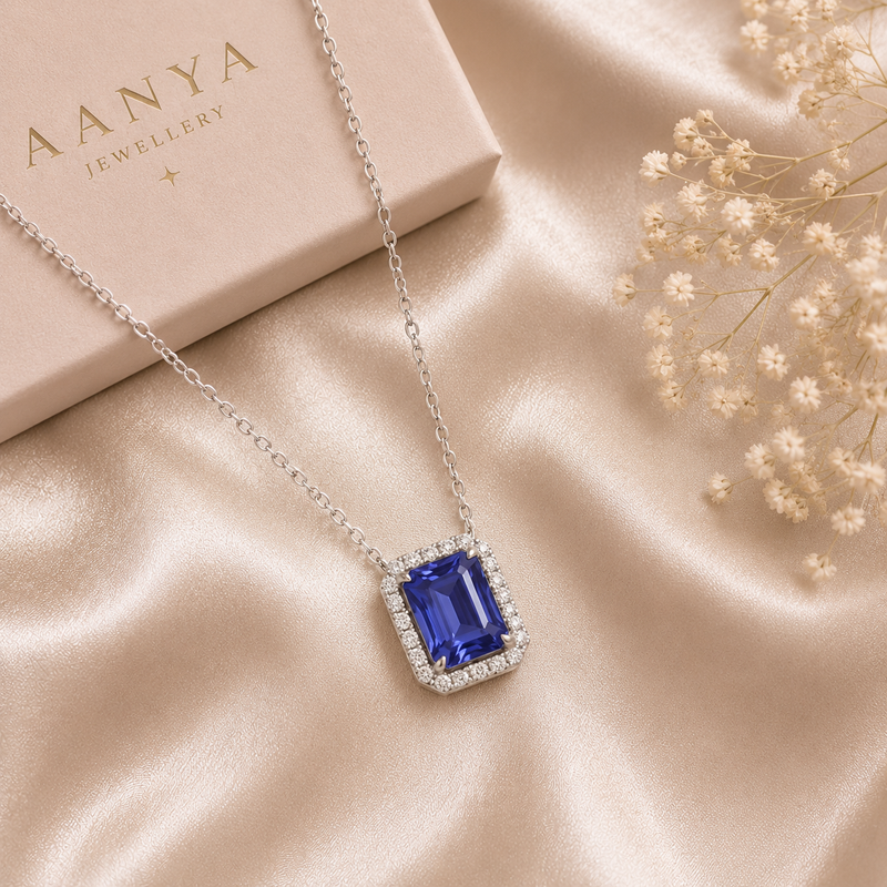 Tanzanite Blue Solitaire Pendant Chain displayed on luxury champagne satin backgrounda